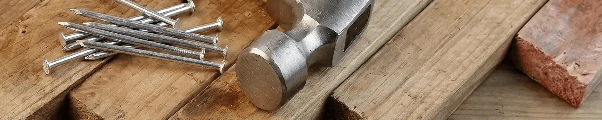 Hammer and nails on hardwood flooring boards in Tacoma, WA