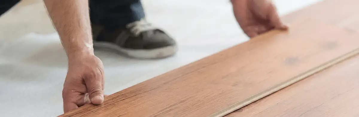 A professional installing laminate flooring in Tacoma, WA